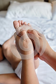 Mother Giving Kid Foot Therapy Massage To Stimulate His Growth