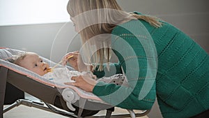 Mother giving pie to her baby