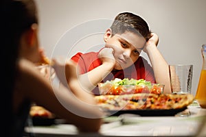 Mother Giving Salad Instead Of Pizza To Overweight Son