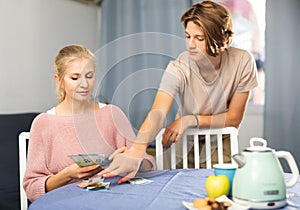 Mother giving some cash her teenager son