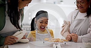 Mother, grandmother and child in kitchen with cookies, teaching and learning together with family in home. Mom, grandma