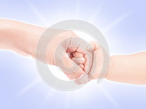 Mother hand holding baby hand