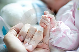Mother hand holding the baby. Photo taken in the neonatal Gynecological