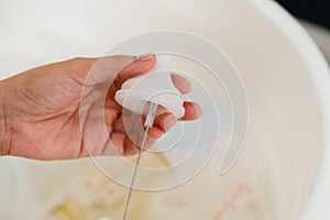 mother hand washing the baby nipple of milk bottle