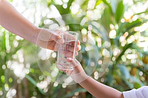 Mother handed the glass to the child.