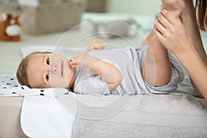 mother hands changing baby nappy