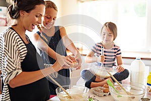 Mother, happy family or kids baking in kitchen with siblings learning cookies recipe or mixing pastry at home. Mom