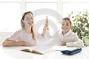 Mother help Black boy doing homework at home