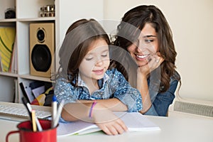 Mother helping child with homework photo