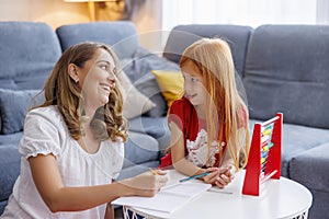 Mother helping daughter with math homework