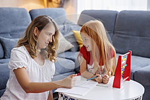 Mother helping daughter study math
