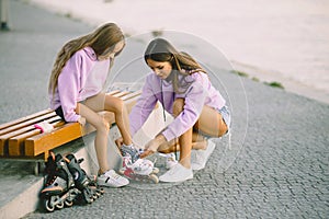 Mother helping daughter to dress rollers at park