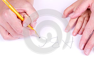 Mother helping daughter write alphabet