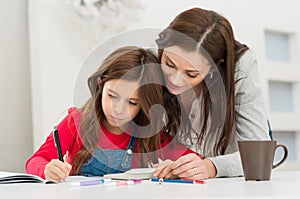 Mother Helping Her Daughter While Studying