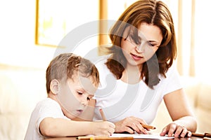 Mother helping in homework to her son