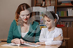 Mother helping kid after school. preschooler doing homework with help of tutor. home teaching concept.