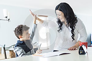 Mother Helping Son for the Homework at home