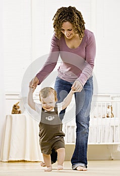 Mother helping son learn to walk