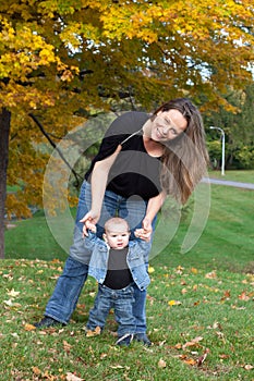 Mother helps baby to walk