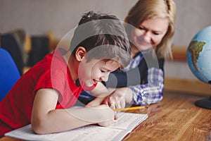 Mother helps son doing homework