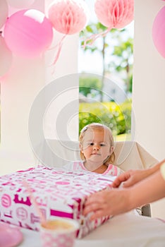 Mother Helps to Unwrap Birthday Present