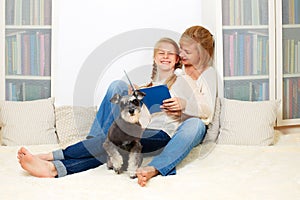 Mother with her 10 years old kid girl reading the book
