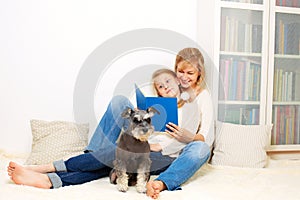 Mother with her 10 years old kid girl reading the book, casual lifestyle photo series.