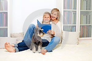 Mother with her 10 years old kid girl reading the book, casual lifestyle photo series.