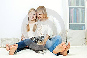 Mother with her 10 years old kid girl sitting home