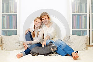 Mother with her 10 years old kid girl sitting home, casual lifestyle photo series.