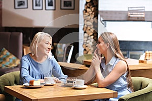 Mother and her adult daughter spending time in cafe