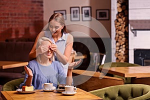 Mother and her adult daughter spending time in cafe