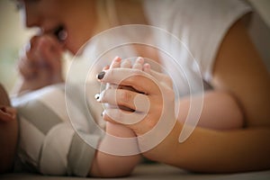 Mother with her baby boy at home playing.