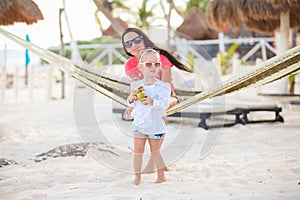 Mother with her baby daughter in hammock on a