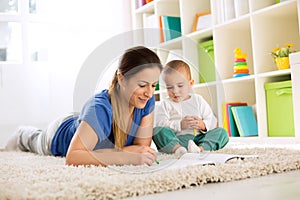 Mother with her child drawing with wax colors