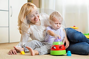 Mother and her child playing with colorful logical