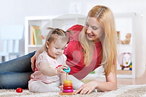 Mother with her child playing with wooden blocks