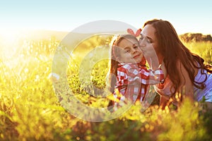 Mother with her child in spring field