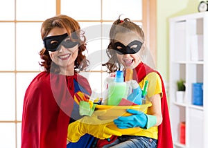 Mother and her child in Superhero costume. Mum and kid ready to house cleaning. Houseworking and housekeeping.