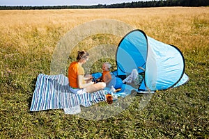 Mother with her children, having a picnic