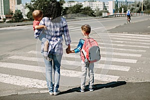 Mother and her children about to cross road