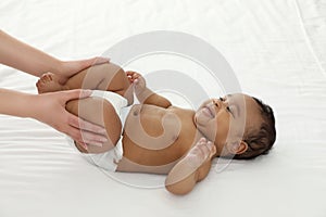 Mother and her cute child. Baby massage and exercises