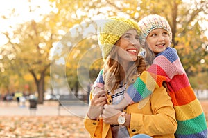 Mother with her cute daughter spending time together in park