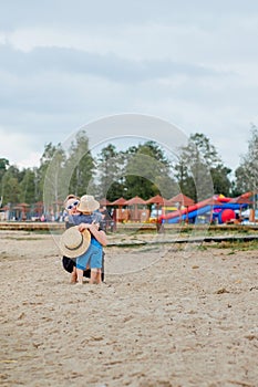 Mother and her cute little son enjoying time at beach