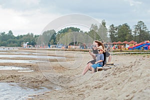 Mother and her cute little son enjoying time at beach