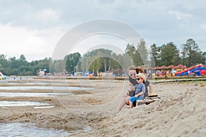 Mother and her cute little son enjoying time at beach