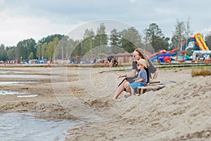 Mother and her cute little son enjoying time at beach