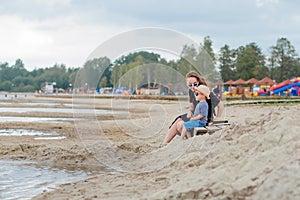 Mother and her cute little son enjoying time at beach