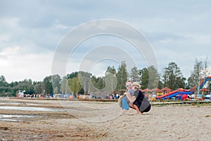 Mother and her cute little son enjoying time at beach