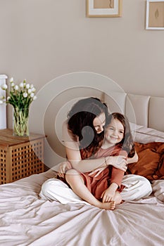 Mother and her daughter child girl playing and hugging. Happy loving family.